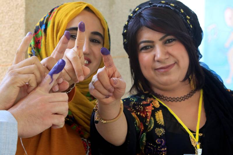 Voters show their ink-stained fingers during the Iraqi Kurdish independence referendum in Halabja, Iraq. Alaa Al Marjani / Reuters
