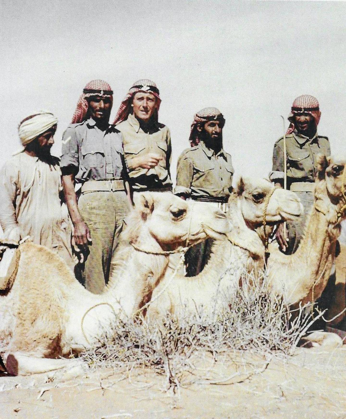 Anthony Rundell , second left, in 1960 as a squadron leader in the Trucial Oman Scouts with some of his men and their camels in Al Ain