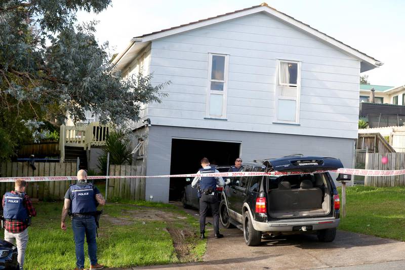 New Zealand Police guard a house on Rena Place after arresting two men. Getty Images