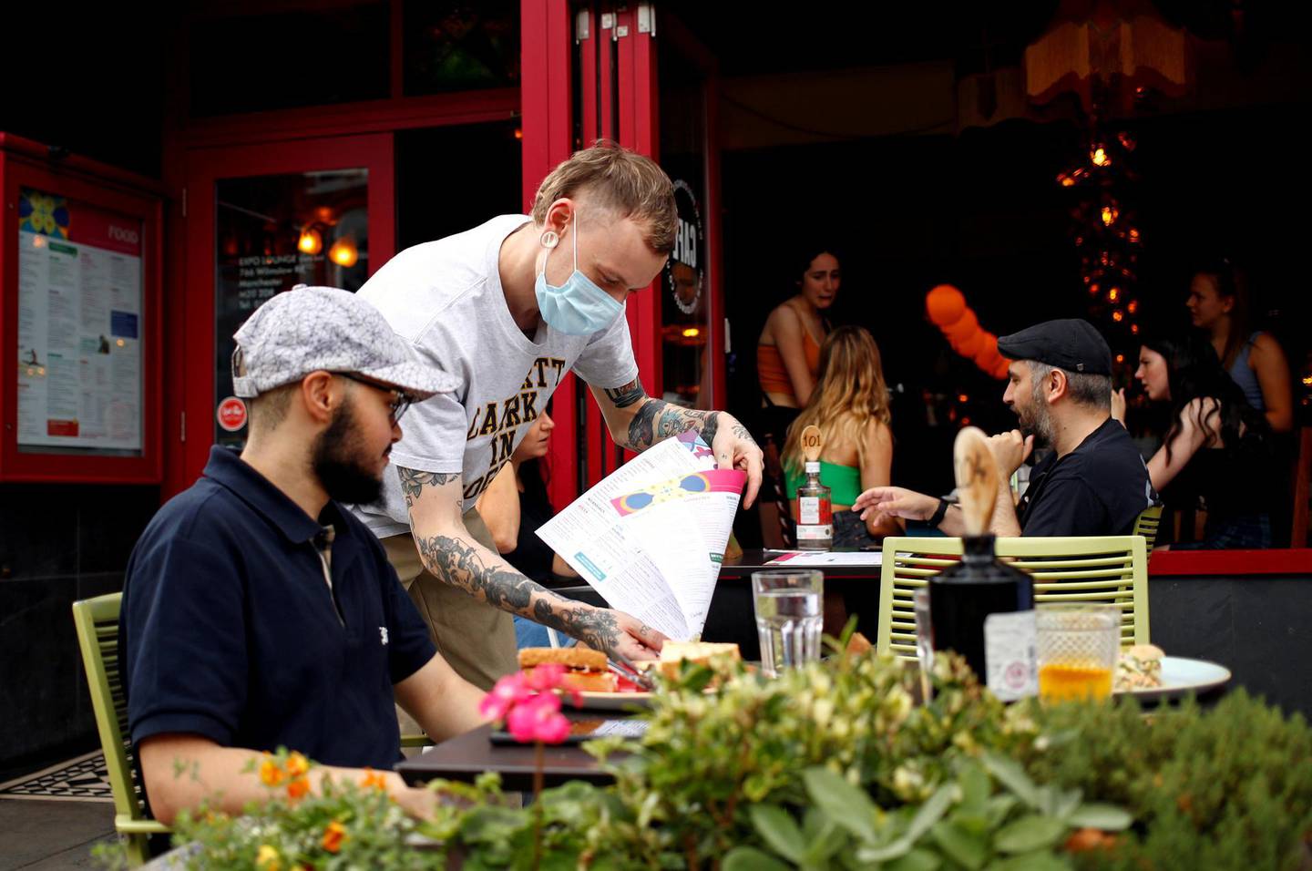 FILE PHOTO: A diner has a lunch outside a restaurant in Didsbury, as the 'Eat Out to Help Out' scheme continues, amid the coronavirus disease (COVID-19) outbreak, in Manchester, Britain, August 10, 2020.  REUTERS/Jason Cairnduff/File Photo