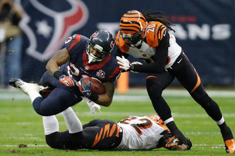 Houston Texans' Arian Foster is tackled by Reggie Nelson of the Cincinnati Bengals.