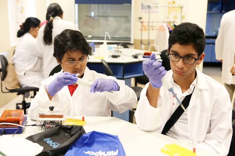 ABU DHABI , UNITED ARAB EMIRATES – Aug 22 , 2016 : Pritvik Sinhadc ( left ) and Jawad Asaria ( right ) from Dubai College learning how to test food for bacterial contamination through PCR or DNA during the Genes in Space workshop in the lab of Emirates College for Advanced Education in Abu Dhabi. ( Pawan Singh / The National ) For News. ID No - 39415 *** Local Caption ***  PS2208- SPACE WORKSHOP04.jpg