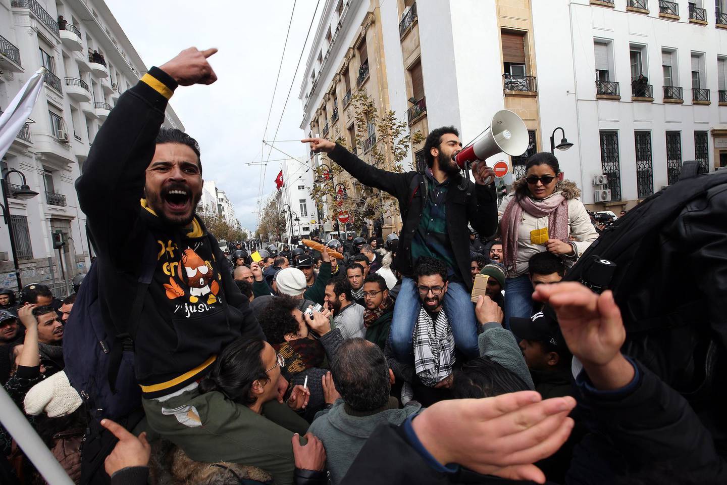 epa06433388 Tunisian protesters shout slogans during a demonstration after the government announced tax hikes and austerity measures and against increased prices of some goods in Tunis, Tunisia, 12 January 2018. Protests were held across Tunisia since 08 January after a the new year's price and tax increase came into effect on 01 January 2018.  EPA/MOHAMED MESSARA