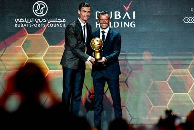 Portuguese football agent Jorge Mendes (R) poses with Juventus' Portuguese forward Cristiano Ronaldo after receiving the Best Agent of the Year Award during the 10th edition of the Dubai Globe Soccer Awards in Dubai. AFP