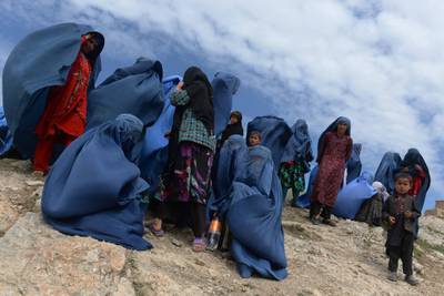 Villagers are pictured near the scene in the landslide-hit Aab Bareek village in Argo district of Badakhshan province. May 5, 2014. Shah Marai / AFP