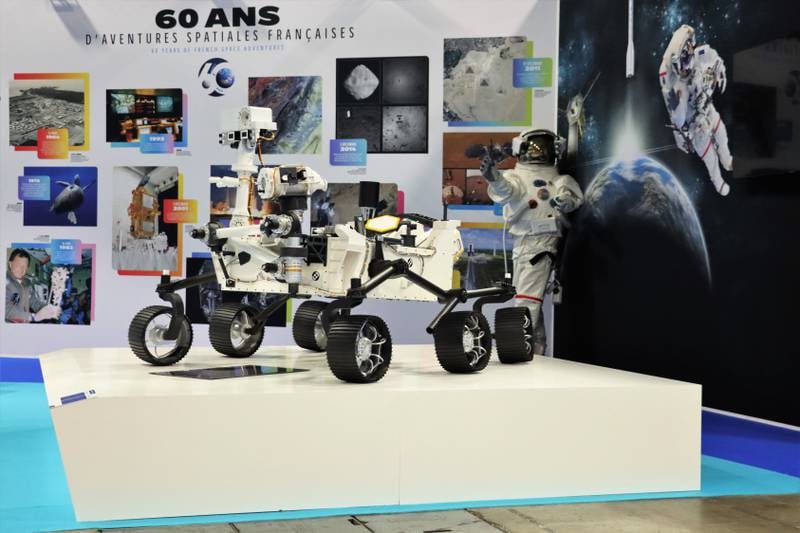 A model of an exploration rover and astronaut suit at the IAC 2022 in Paris.