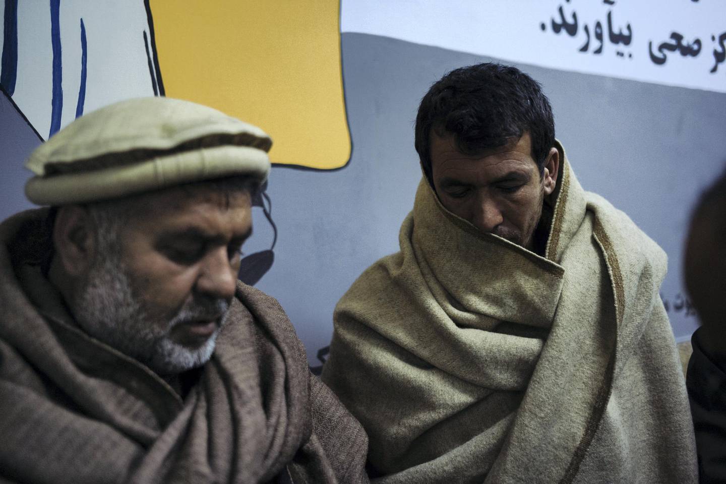 January 15th, 2019 - Kabul, Kabul, Afghanistan: Tooryalai's uncle, Noorallen, and brother, Baryalai, stand outside of the ICU in the Wazir Akbar Khan public hospital in Kabul. Tooryalai was wounded in an explosion while out getting bread for dinner.The attack on the Green Village, a compound in Kabul that houses foreign workers and NGO's, initially killed 9 and wounded over 120 Afghans who lived in the vicinity. There was also extensive property damage to the surrounding homes and shops. Ivan Flores/The National