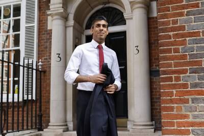 Mr Sunak outside his campaign office in central London. EPA