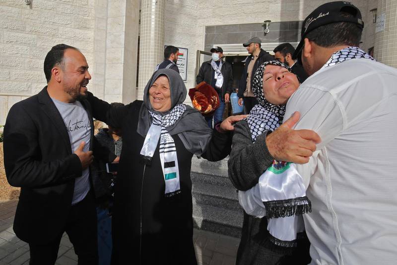 Palestinians welcome relatives leaving the Muscat Medical Center in Khan Yunis after 21 days in quarantine since their arrival to one of the entry crossings to the besieged Gaza Strip, returning from a trip abroad.  AFP
