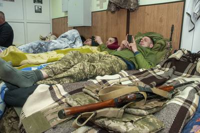 Ukrainian servicemen rest in Kharkiv. AP