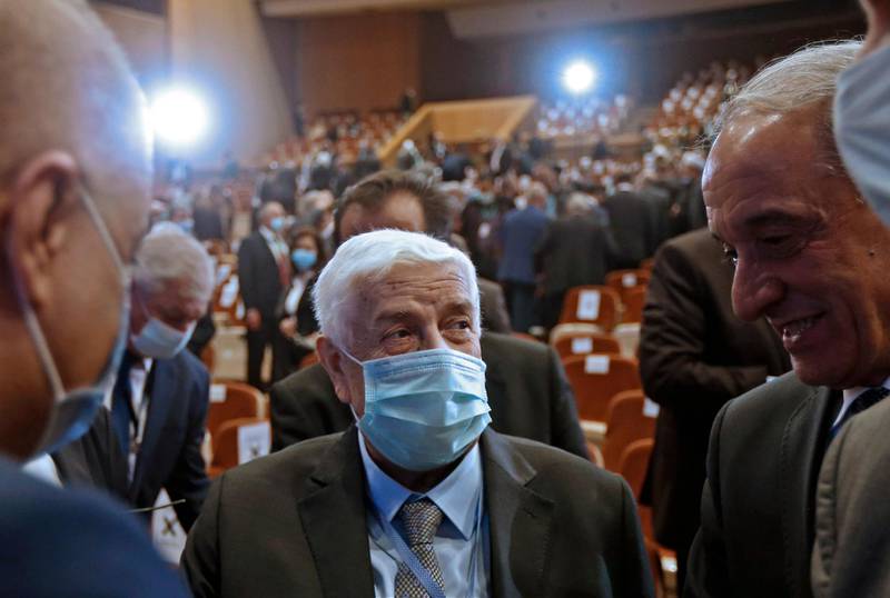 Syria's Foreign Minister Walid al-Muallem, mask-clad against the COVID-19 coronavirus pandemic, attends the opening session of the international conference on the return of refugees held in Damascus on November 11, 2020. - Syria's government kicked off a two-day Russia-backed conference in Damascus towards facilitating the return of millions of Syrian refugees to the war-torn country, despite reservations within the international community. (Photo by LOUAI BESHARA / AFP)