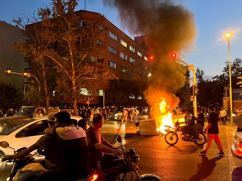 A police motorcycle burns during a protest in Tehran, Iran, over the death of Mahsa Amini, a woman who died in police custody. Reuters