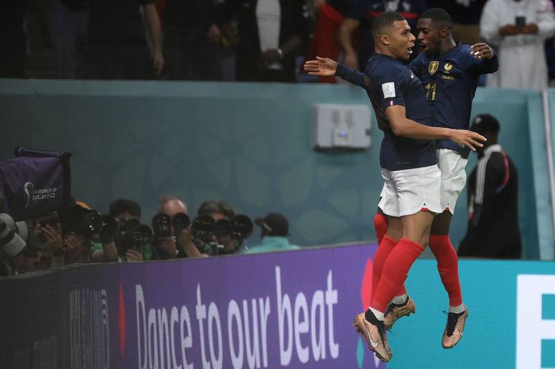 TOPSHOT - France's forward #10 Kylian Mbappe (L) celebrates with France's forward #11 Ousmane Dembele after he scored during the Qatar 2022 World Cup Group D football match between France and Australia. AFP