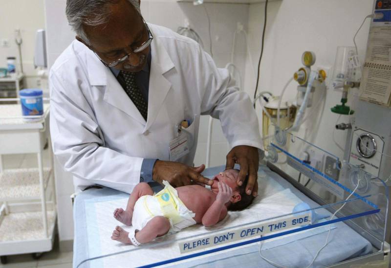AL AIN. 23rd July 2008. HOSPITAL FEATURE. Dr.Thomas Mathew checks  a new born baby in  the special care baby unit at the Oasis hospital in Al Ain.  Stephen Lock  /  The National.