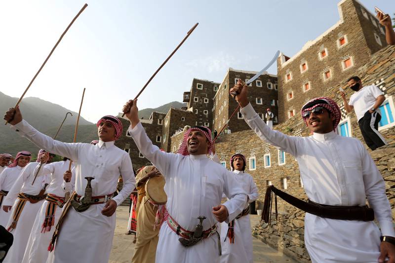Saudi men perform a traditional sword dance at Rijal Almaa, on the outskirts of Abha, in 2020. Reuters