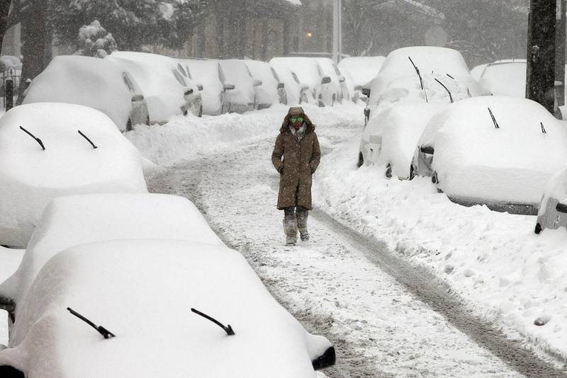 A woman walks along a street in the East Falls section of Philadelphia on Saturday. A blizzard with hurricane-force winds brought much of the East Coast to a standstill Saturday, dumping as much as 3 feet of snow, stranding tens of thousands of travelers. Alejandro A Alvarez / The Philadelphia Inquirer via AP