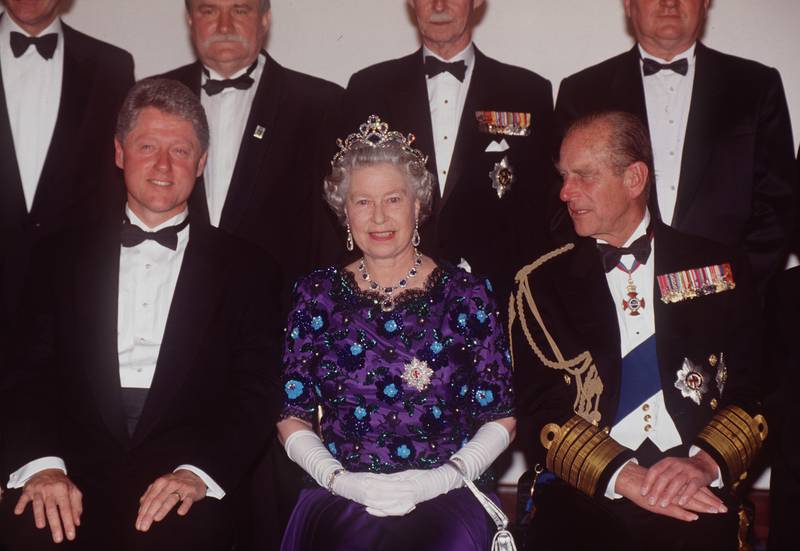 Queen Elizabeth and Prince Philip sit with former US president Bill Clinton at a banquet held at Portsmouth Guildhall in June 1994. Getty Images