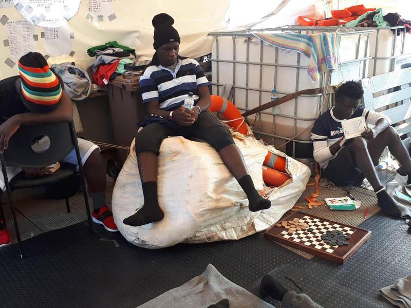epa07677817 Some migrants on board the vessel  Sea-Watch 3 at sea in the Mediterranean, 27 June 2019. Sea-Watch 3 captain Carola Rackete told journalists on 27 June that she had been promised 'a rapid solution' for the 42 desperate migrants on board the Dutch-flagged German NGO run rescue ship standing one mile off Lampedusa.  EPA/MATTEO GUIDELLI