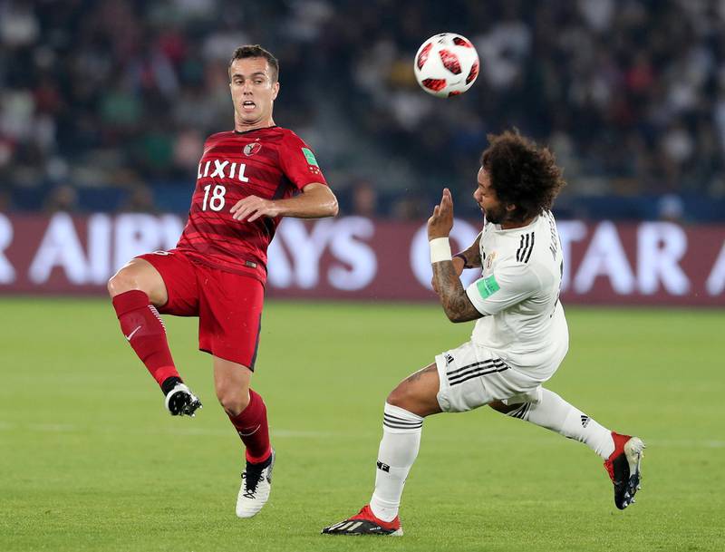 Abu Dhabi, United Arab Emirates - December 19, 2018: Marcelo of Real Madrid and Serginho of Antlers compete during the game between Real Madrid and Kashima Antlers in the Fifa Club World Cup semi final. Wednesday the 19th of December 2018 at the Zayed Sports City Stadium, Abu Dhabi. Chris Whiteoak / The National