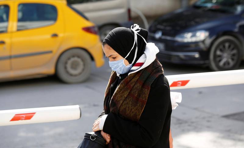 A woman wears a protective face mask as she walks in Tunis, Tunisia.  Reuters