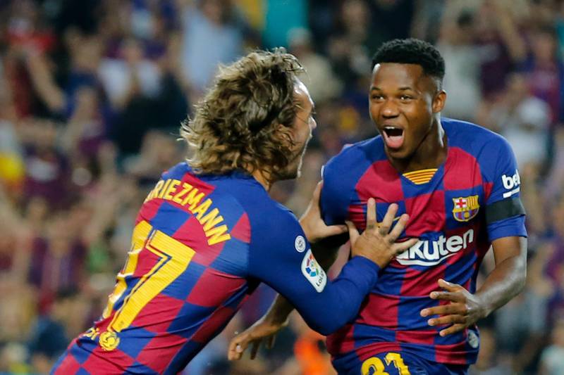 Barcelona´s Guinea-Bissau forward Ansu Fati (R) is congratulated by Barcelona's French forward Antoine Griezmann after scoring a goal during the Spanish league football match FC Barcelona against Valencia CF at the Camp Nou stadium in Barcelona on September 14, 2019. / AFP / PAU BARRENA
