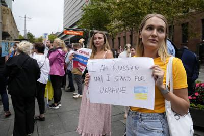 People chant, carry placards and wave Ukrainian flags as they gather in Sydney, to demonstrate against Russian attacks on its neighbour. AP