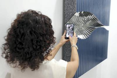 Dubai, United Arab Emirates - Reporter: Alexandra Chaves. Arts and Lifestyle. A visitor takes a picture of Mirror 5 by Aref Montazeri. Art Dubai 2021 opens at the DIFC. Tuesday, March 30th, 2021. Dubai. Chris Whiteoak / The National