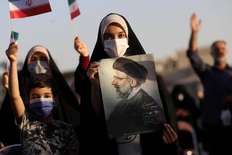 Ebrahim Raisi supporters display his portrait during a celebratory rally for his presidential election victory in Tehran. He will succeed President Hassan Rouhani, who is coming to the end of his second term in office. Reuters