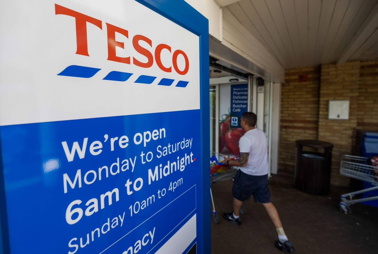 Tesco said its customers are cutting back on luxury items and switching to cheaper brands. Bloomberg

