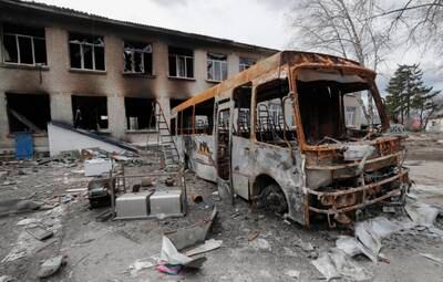 Debris of a school bus near a damaged school that was a base for Russian troops in Bohdanivka, Ukraine. EPA