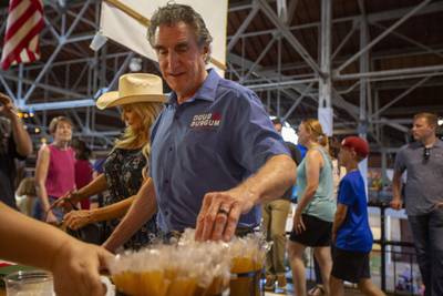 North Dakota Governor Doug Burgum visits the Iowa Honeybee Association booth in the Agriculture Building at the fair. Bloomberg