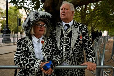 A Pearly king and queen, who raise money for charity, on the procession route in London. AFP