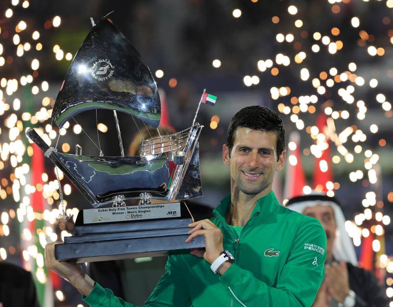 Serbia's Novak Djokovic holds the trophy after he beats Stefanos Tsitsipas of Greece in the final match of the Dubai Duty Free Tennis Championship in Dubai, United Arab Emirates, Saturday, Feb. 29, 2020. (AP Photo/Kamran Jebreili)