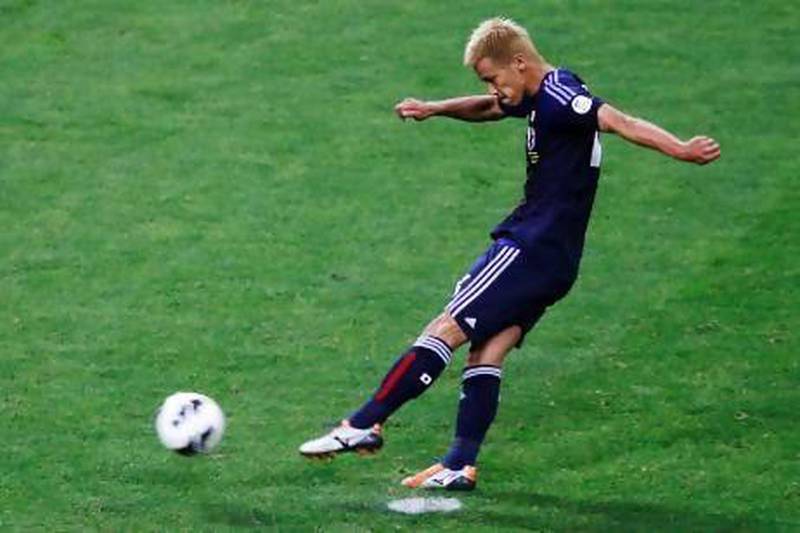 Japan's Keisuke Honda scores on a penalty kick against Australia on Tuesday and the 1-1 draw qualified Japan for next year's World Cup. Toru Hanai / Reuters