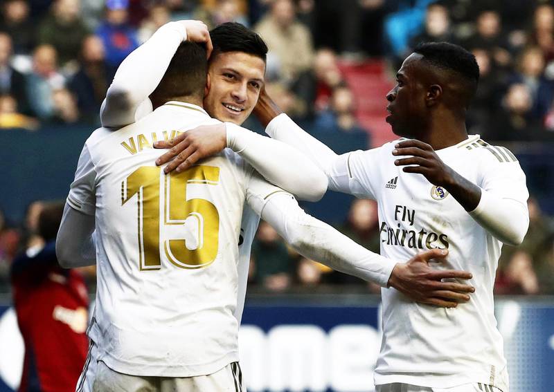 epa08206093 Real Madrid's Luka Jovic (C) celebrates with teammates Federico Valverde (L) and Vinicius Junior (R) after scoring the 4-1 lead during the Spanish La Liga soccer match between CA Osasuna and Real Madrid at El Sadar stadium in Pamplona, northern Spain, 09 February 2020.  EPA/JESUS DIGES