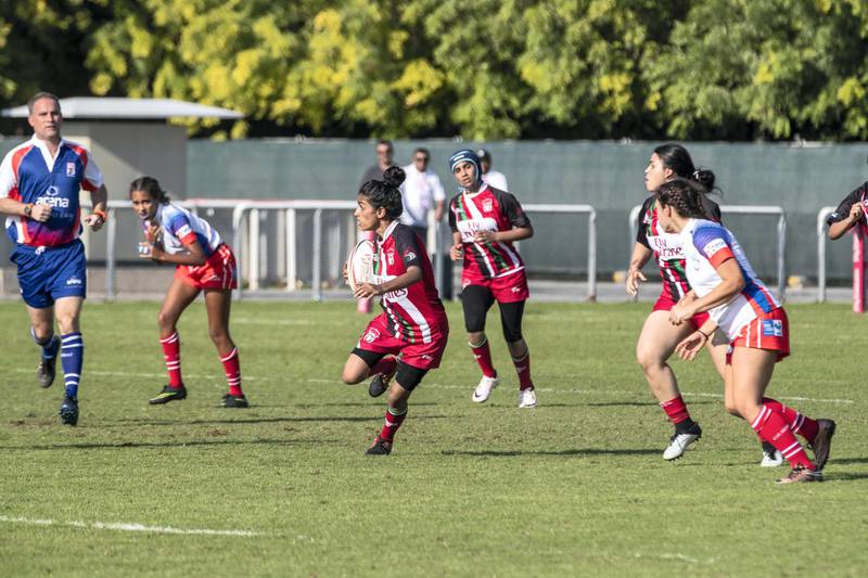 ABU DHABI, UNITED ARAB EMIRATES. 29 November 2018. First day of the Rugby Sevens Tournament. Al Maha School girls team of all Emirati Female Players (Red and black colours). (Photo: Antonie Robertson/The National) Journalist: Paul Radley. Section: Sport.