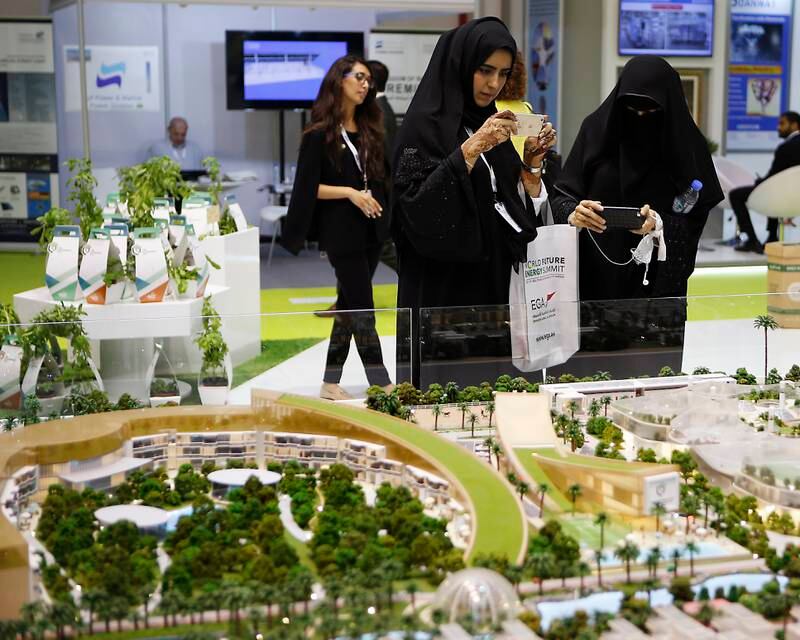 ABU DHABI, UNITED ARAB EMIRATES -17January 2017 - Visitors take photographs of Sustainable City in Dubai regions first Net Zero Operational Sustainable community model displayed at the World Future Energy Summit 2017 at the Abu Dhabi Exhibition Centre. Ravindranath K / The NationalID: 62760 (to go with LeAnne Graves, Dania Al Saadi and Tony McAuley story for Business) *** Local Caption ***  RK1701-WFES18.jpg
