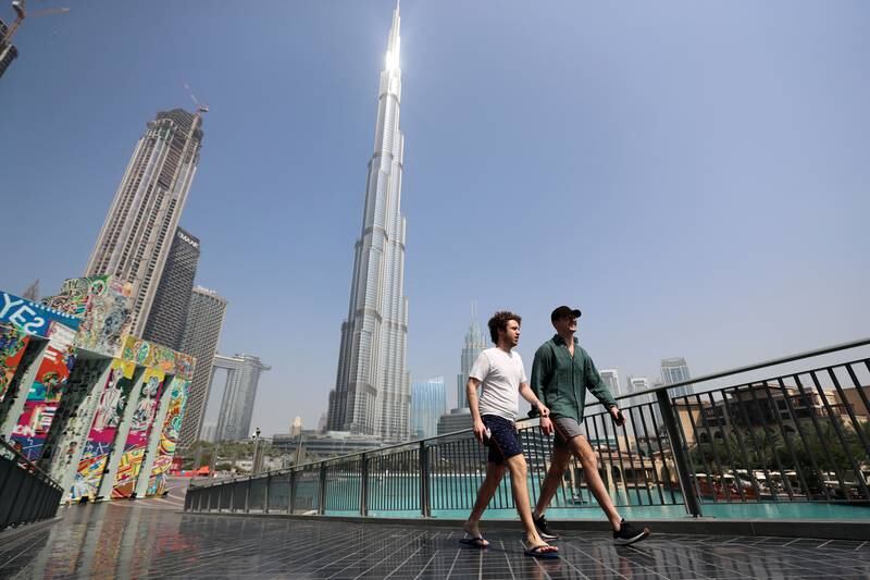 Visitors to Dubai take advantage of not having to wear masks in open spaces any more. Chris Whiteoak / The National