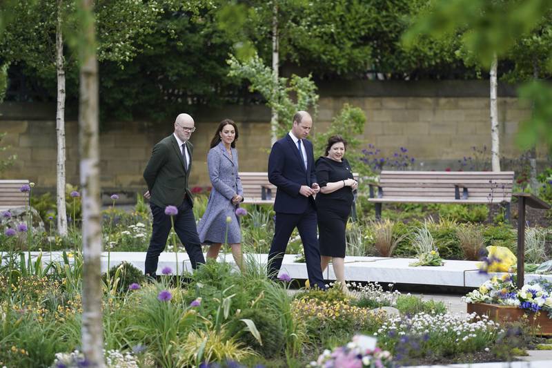 Prince William and his wife Kate are shown around the Glade of Light Memorial garden by its designer Andy Thomson, outside Manchester Cathedral in northern England. AP Photo