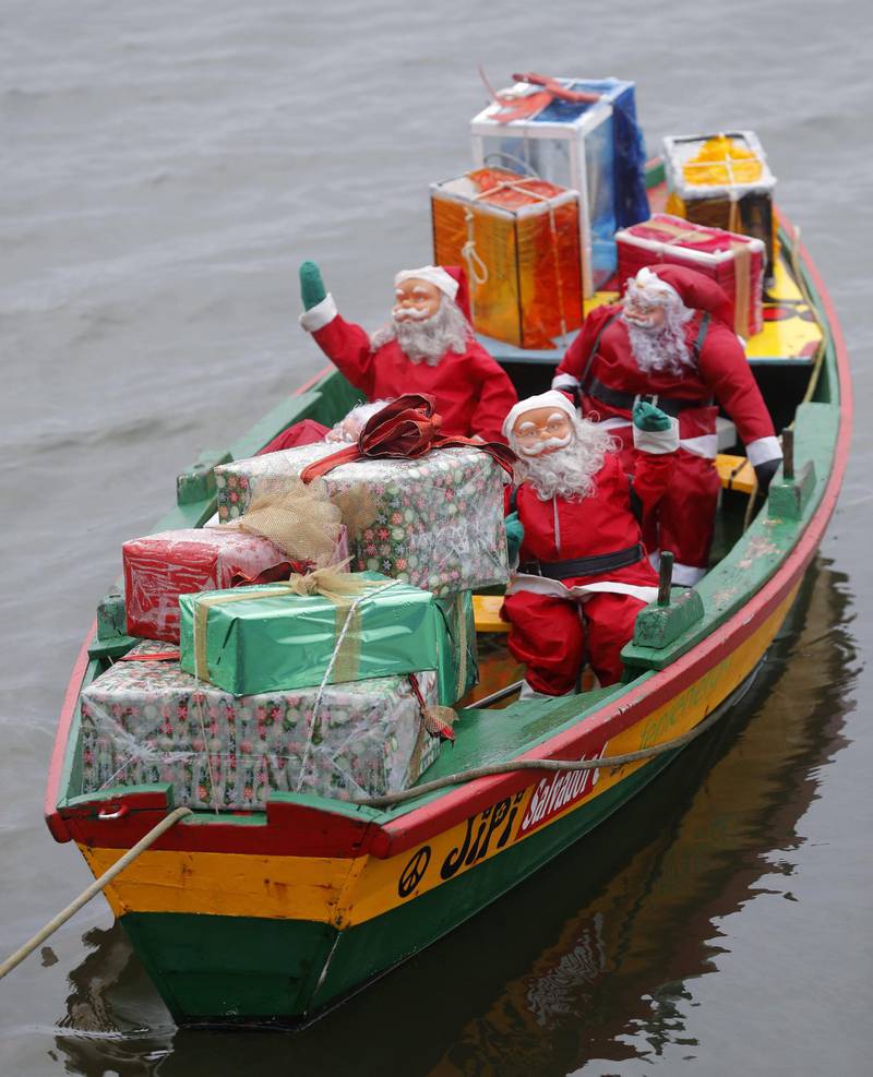 Several Santa Claus figures and lots of presents are on board a 'gamela', a traditional Galician fishing boat during preparations for Christmas, off Cambados' coast, Galicia, northwestern Spain.  EPA