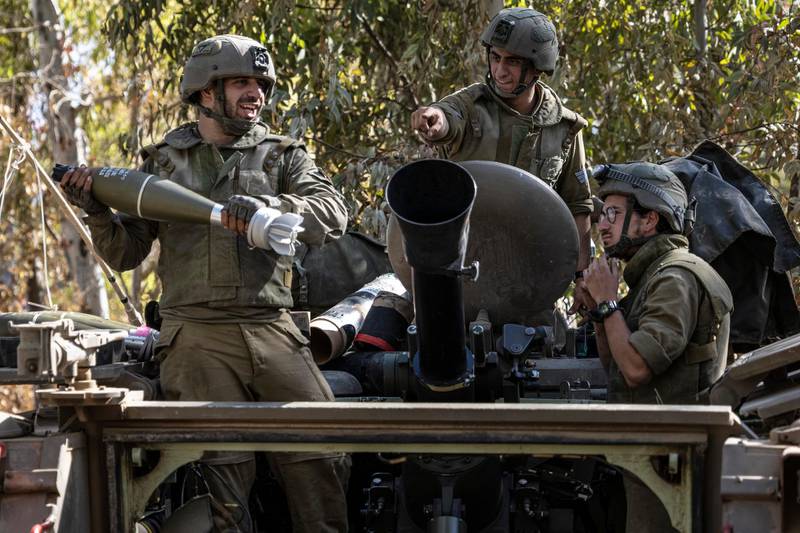 Israeli soldiers load ammunition onto an Armored Personal Carrier (APC) at a staging ground near the Israeli Gaza border, Friday, May 14, 2021. (AP Photo/Tsafrir Abayov)
