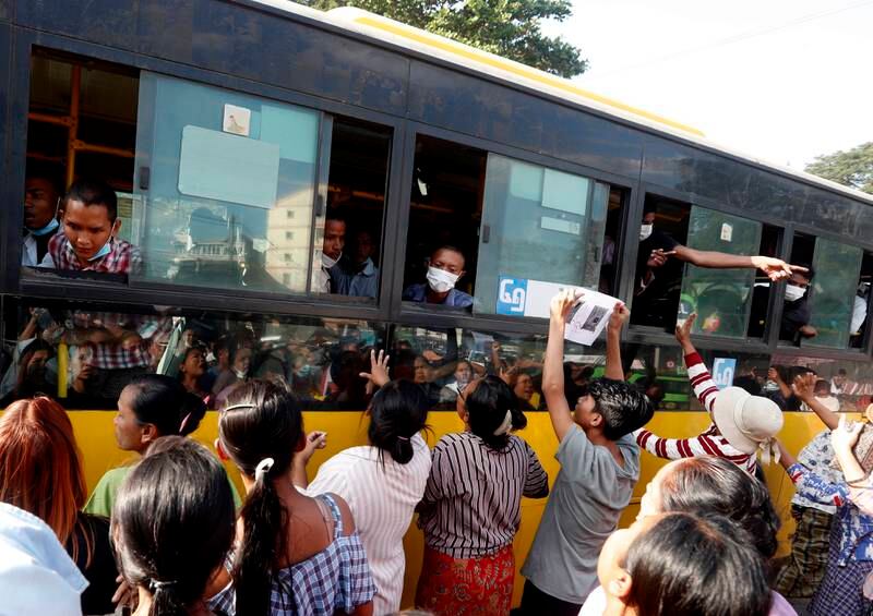 Relatives and friends gather around a bus carrying inmates upon their release from Insein Prison in Myanmar.  EPA 