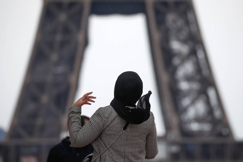 A woman wearing a hijab walks at Trocadero square near the Eiffel Tower in Paris, France, May 2, 2021. Picture taken on May 2, 2021. REUTERS/Gonzalo Fuentes
