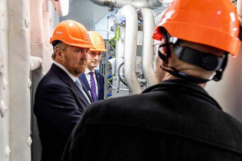 King Willem-Alexander of the Netherlands, left, and North Rhine-Westphalia's State Premier Hendrik Wuest, centre, stand in the engine room of a hydrogen ship in the port of Duisburg, western Germany, last month. AFP