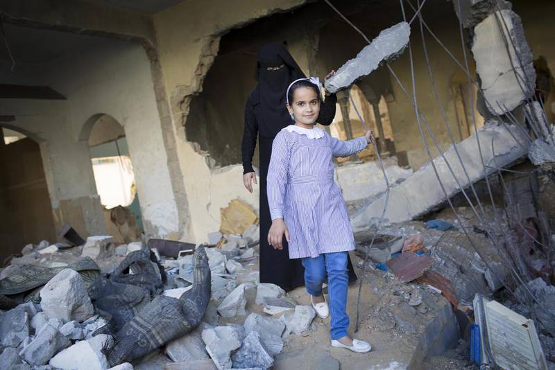 Eman, an 11-year-old who suffers from lung cancer, stands in the wreckage of her home in Gaza. She will be among those to benefit from Yogafest Middle East’s fundraising efforts. Courtesy Celia Peterson