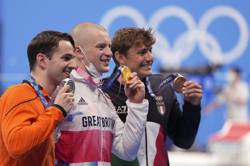 Gold medalist Adam Peaty, centre, of Britain, stands with silver medalist Arno Kamminga of Netherlands, left, and bronze medalist Nicolo Martinenghi of Italy.