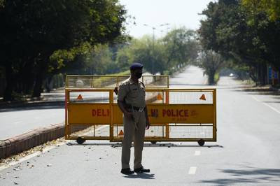 A policeman stands guard at a checkpoint the day after Indian Prime Minister Narendra Modi announced a 21-day government-imposed nationwide lockdown, in New Delhi.  AFP