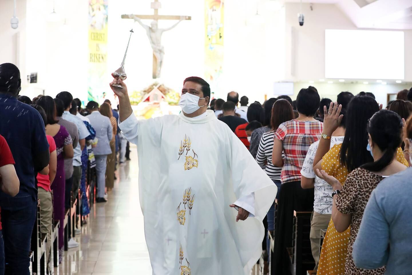 Father Andre during the Easter Sunday mass held at St Mary's Catholic Church in Dubai. Pawan Singh / The National