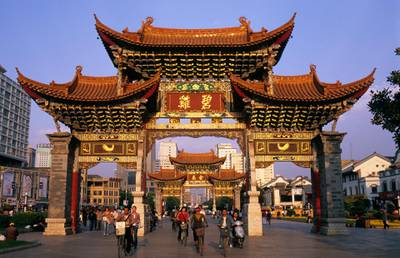 Kunming, China --- Pedestrians and Cyclists Under the Jinma Biji Archway --- Image by © Franck Guiziou/Hemis/Corbis