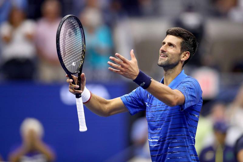 Novak Djokovic of Serbia celebrates winning the first set despite his hurt shoulder. AFP